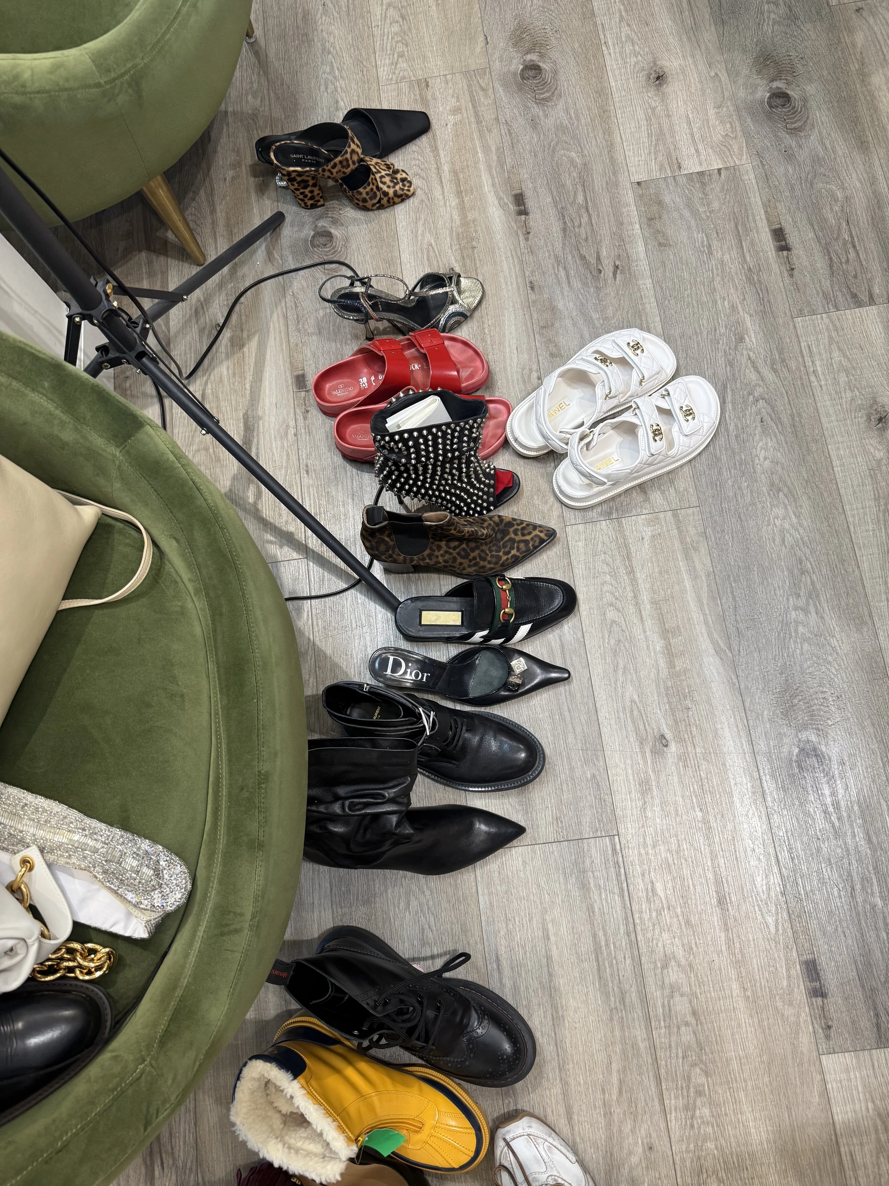 Shoes and accessories arranged on the studio floor during styling preparation.